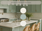 Modern kitchen with green cabinets and white countertops, featuring paint color selection information.